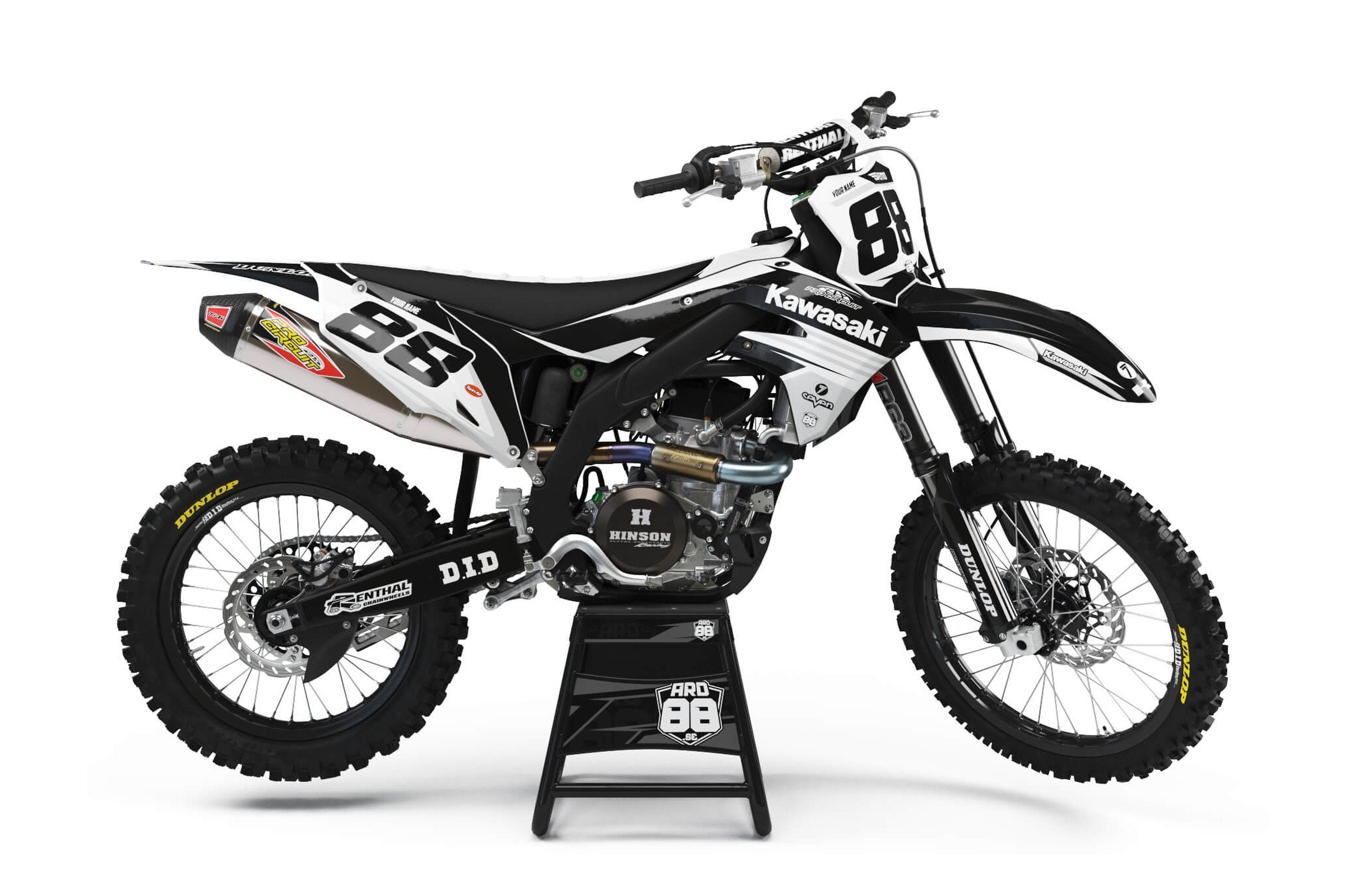 Kawasaki-crosshoj med dekalkitet PC White: vita fält mot svart botten och svarta startnummer mot vitt.