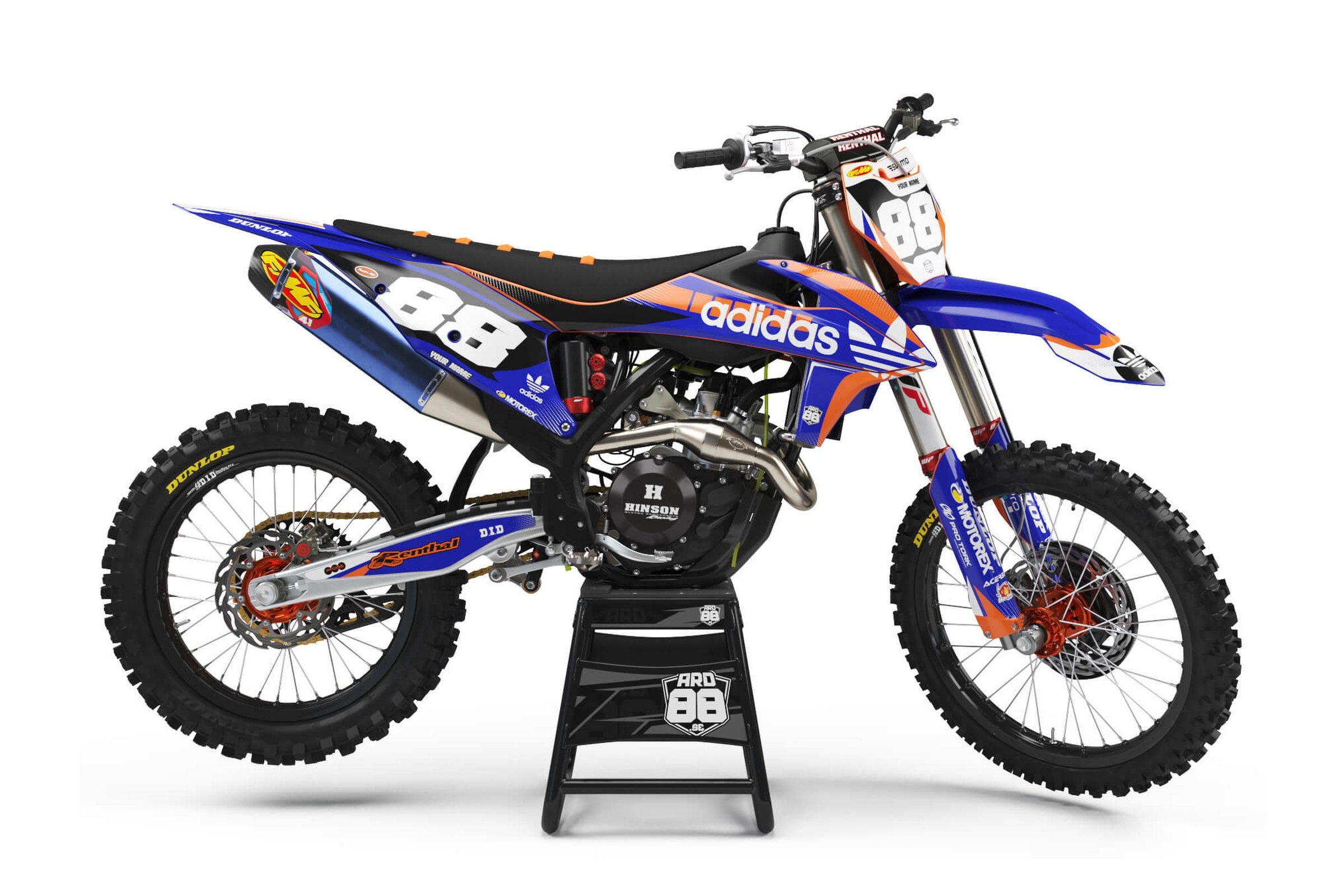 KTM-crosshoj med dekalkit Casual – blå skärmar, kåpor och sidopaneler med orange linjer, vitt 88 mot mörkblå sidopanel och vit framnummerplåt med vita siffror i grå kontur